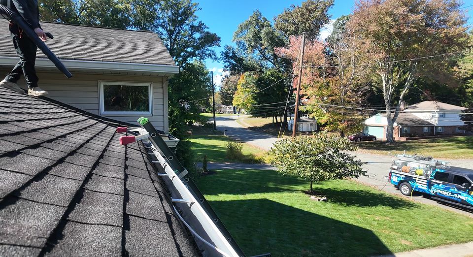 Roof-level view along a gutter during a real Rockland Housewashing job.